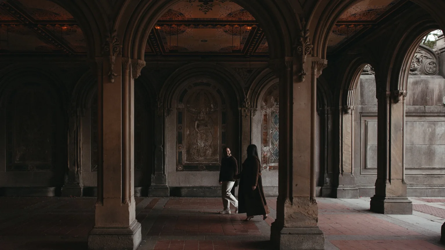 Couple walking through Bethesda Terrace in New York